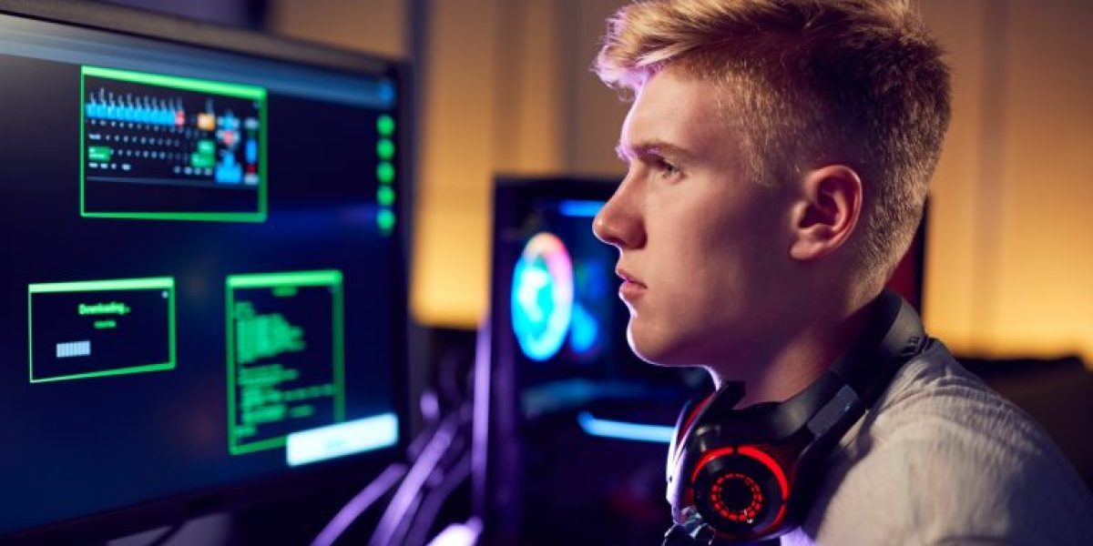 male-teenage-hacker-sitting-in-front-of-computer-screens-bypassing-cyber-security-768x512